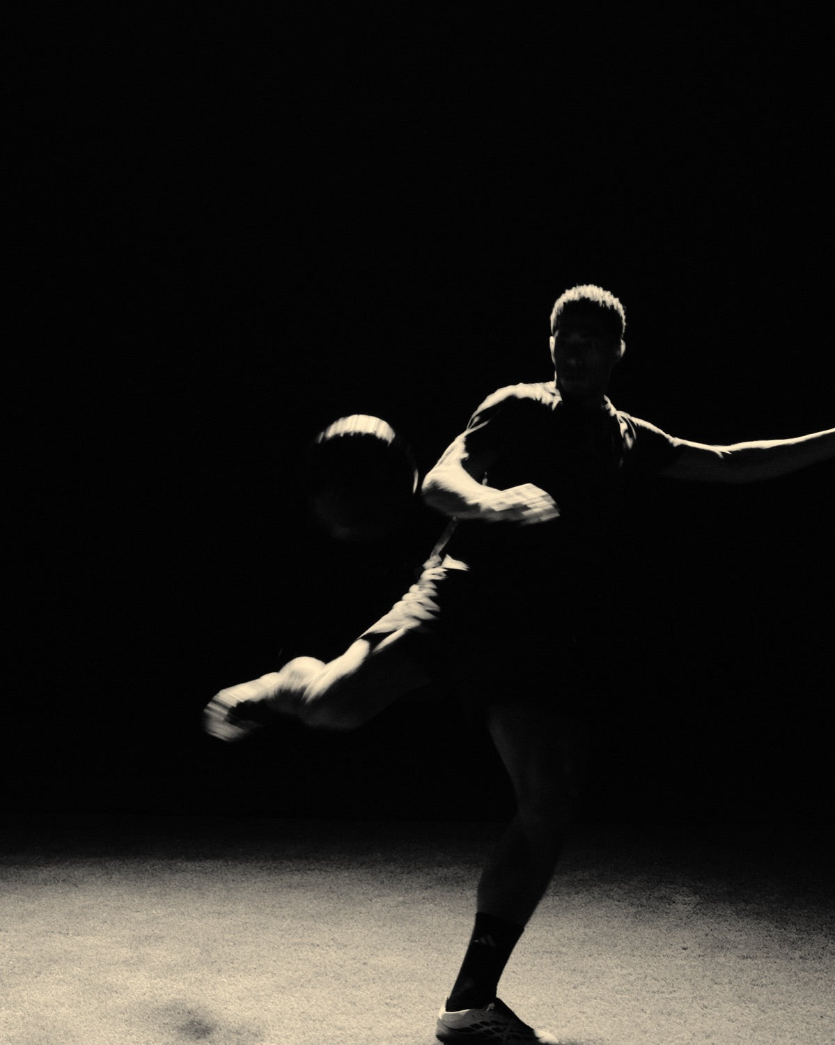 Jude Bellingham striking a ball under a spotlight