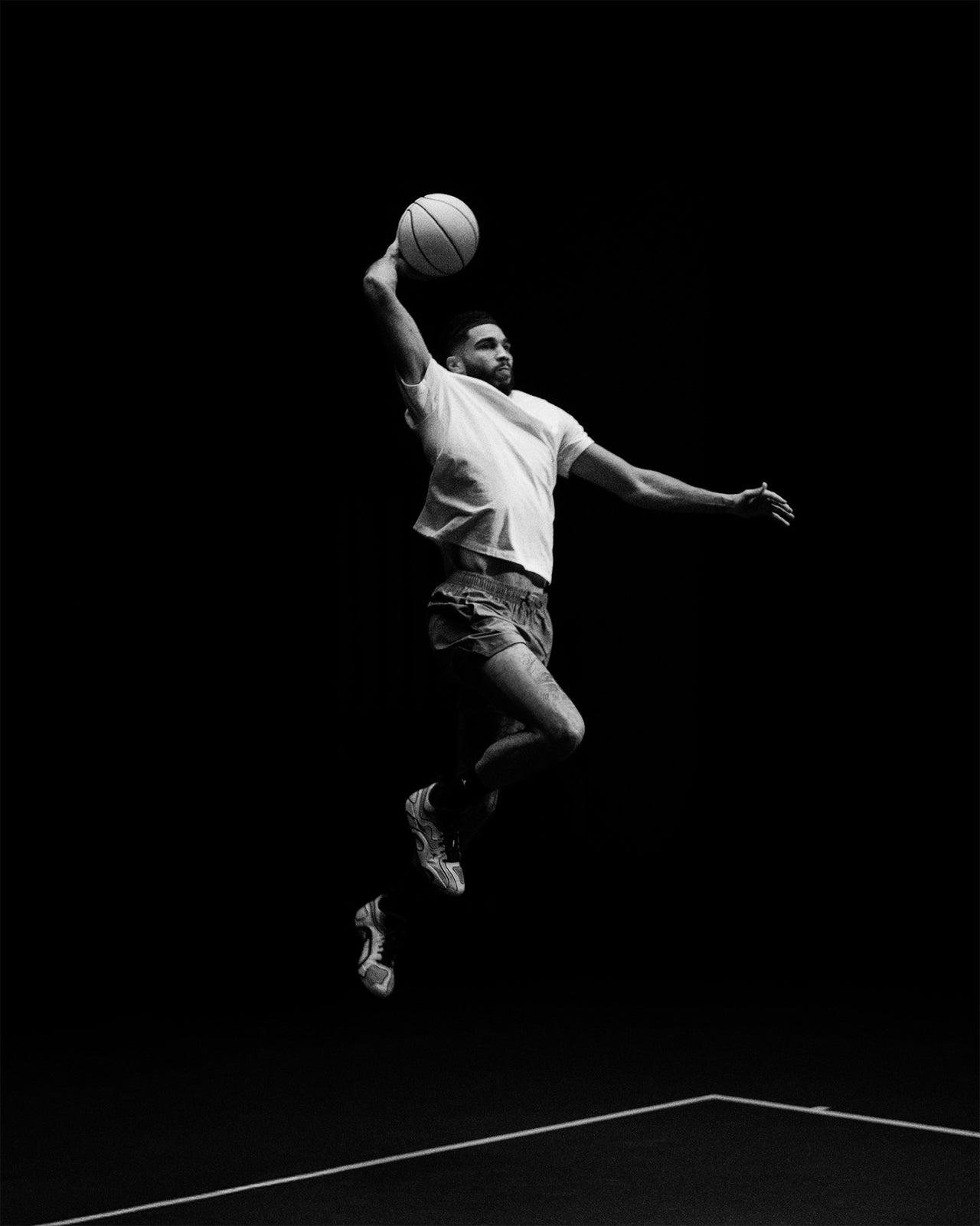 Jayson Tatum in the air, reaching for the ball