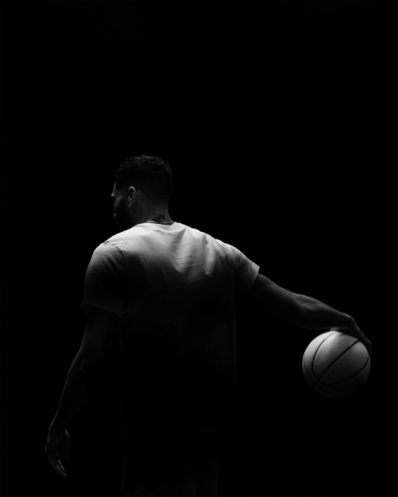 Jayson Tatum from behind, lit from the side