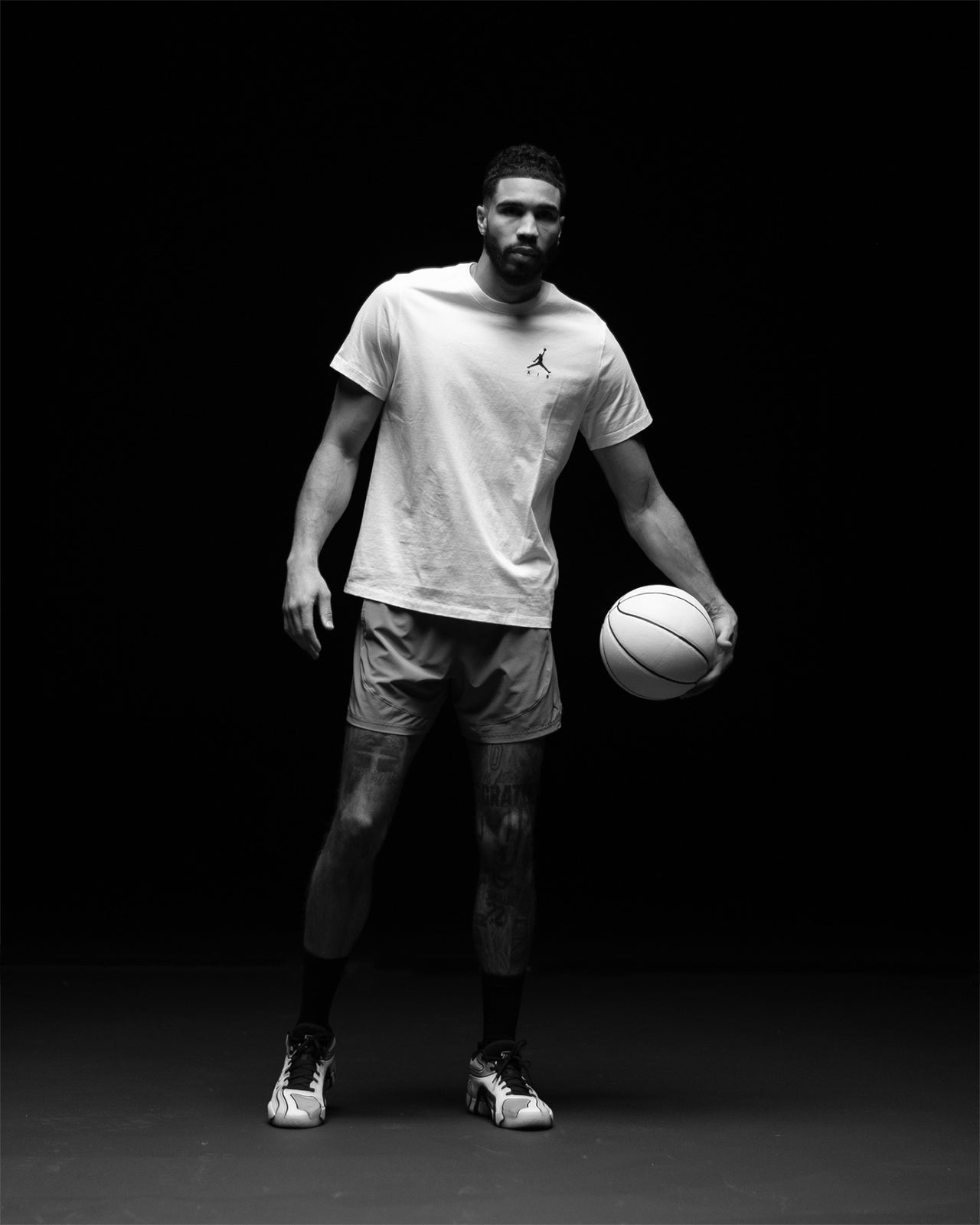 Jayson Tatum standing with a basketball